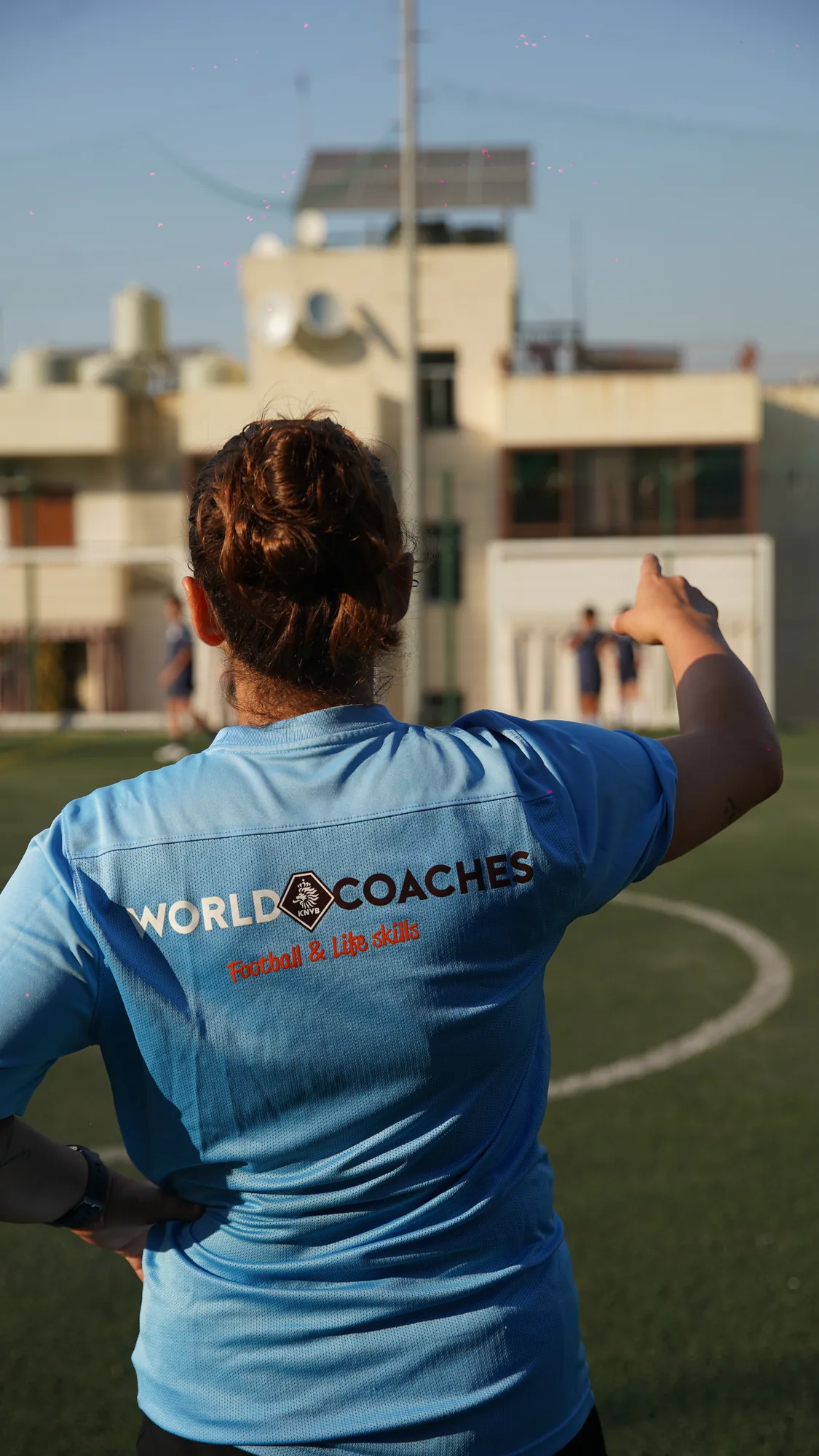 Coach in WorldCoaches kit directing a session